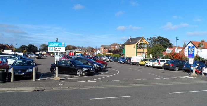 Car park full of cars with pay on foot station
